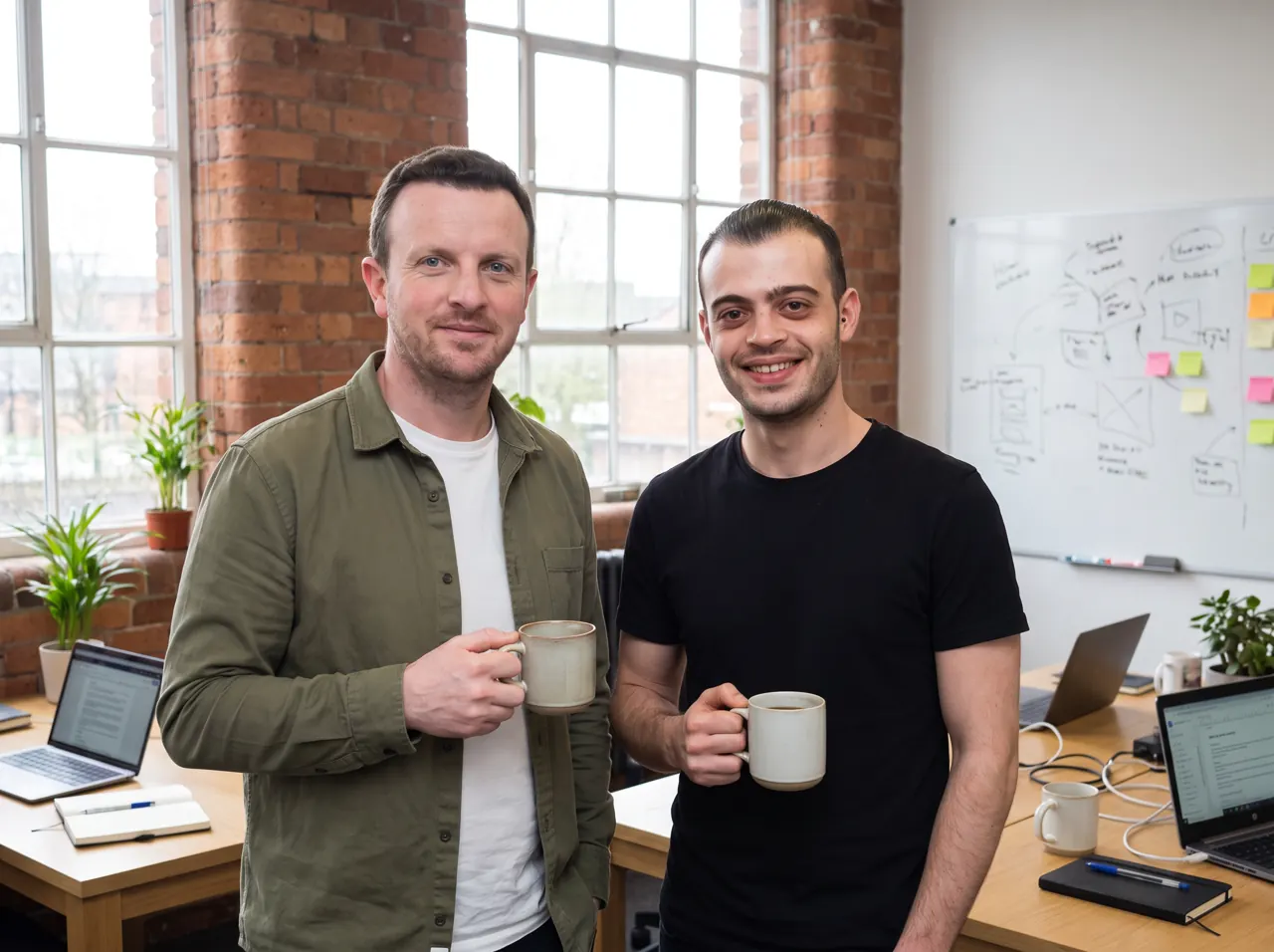 Simon and Michael with coffees in the office